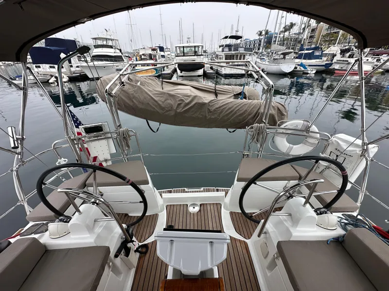 Slide: The Image of 2015 Jeanneau 41DS sailboat with dual steering wheels docked in a marina. - 32