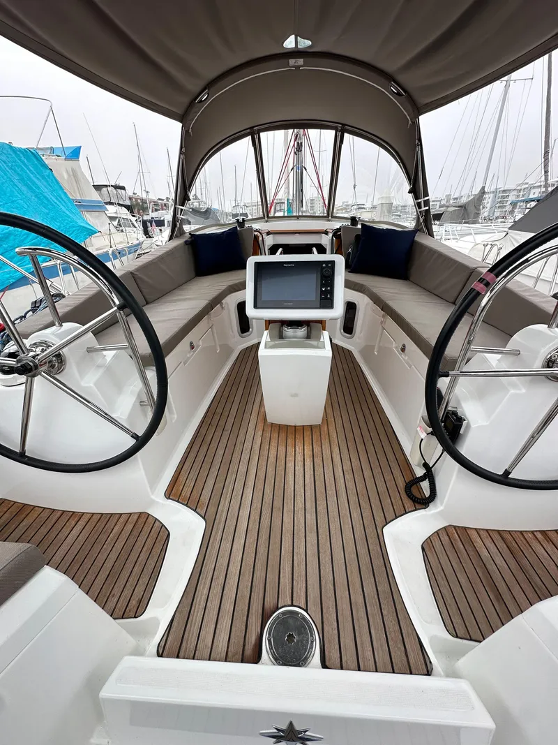 Slide: The Image of 2015 Jeanneau 41DS sailboat cockpit with dual steering wheels and navigation system. - 35