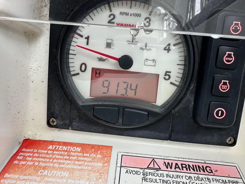 Slide: The Image of Close-up of Jeanneau 41DS 2015 engine gauge displaying 913.4 hours with warning labels. - 39