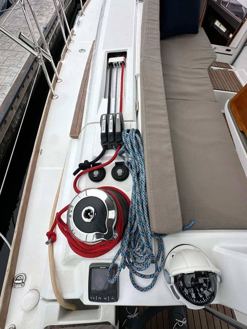 Slide: The Image of Jeanneau 41DS 2015 sailboat deck with winch, ropes, and seating area. - 44