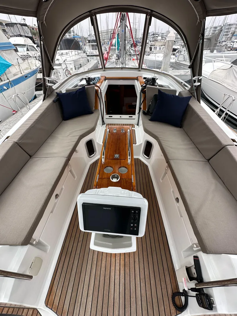 Slide: The Image of 2015 Jeanneau 41DS sailboat cockpit with teak flooring and cushioned seating. - 45