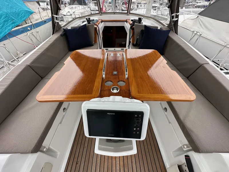 Slide: The Image of 2015 Jeanneau 41DS yacht cockpit with wooden table and navigation equipment. - 46