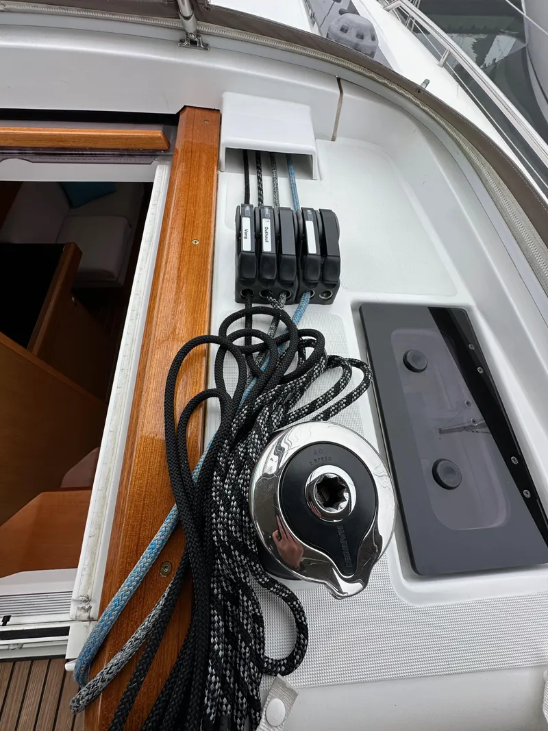 Slide: The Image of Jeanneau 41DS 2015 sailboat deck with winch and ropes, showcasing sleek design. - 48