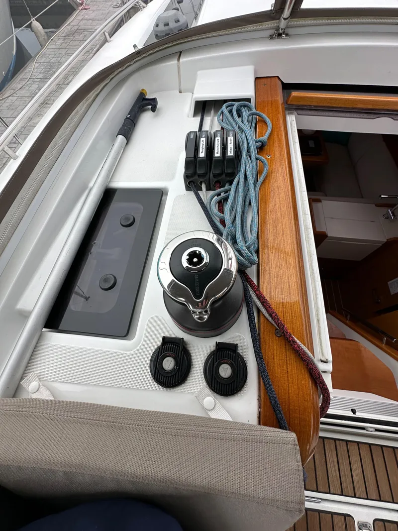 Slide: The Image of 2015 Jeanneau 41DS sailboat deck with winch, ropes, and control panel. - 49