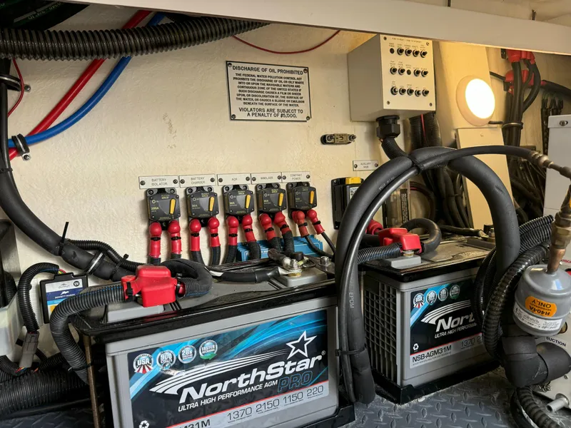 Slide: The Image of Engine room of 2022 Formula 380 Super Sport Crossover OB with fire extinguisher and battery. - 16