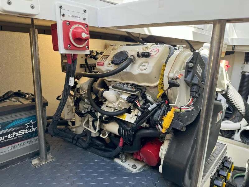 Slide: The Image of Engine compartment of a 2022 Formula 380 Super Sport Crossover OB with hoses and machinery. - 18