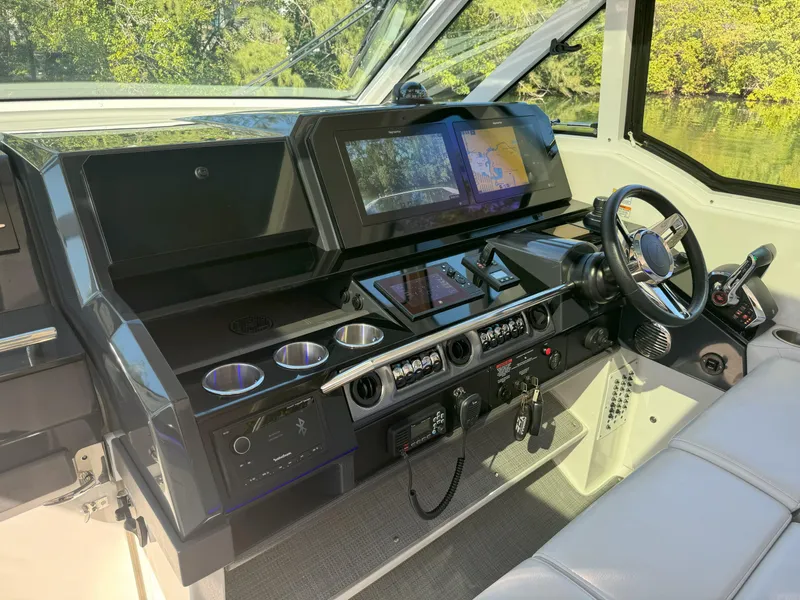 Slide: The Image of 2022 Formula 380 Super Sport Crossover OB dashboard with modern controls and steering wheel. - 21