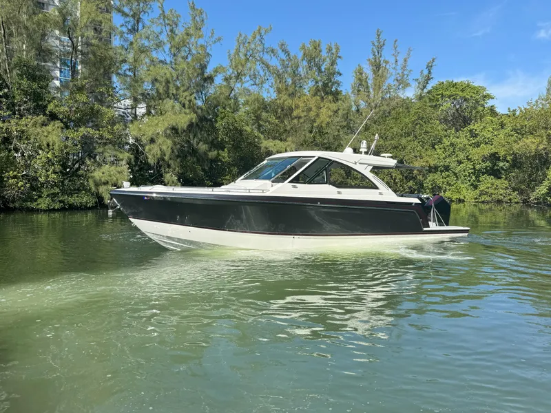 Slide: The Image of 2022 Formula 380 Super Sport Crossover OB cruising on a serene waterway. - 3