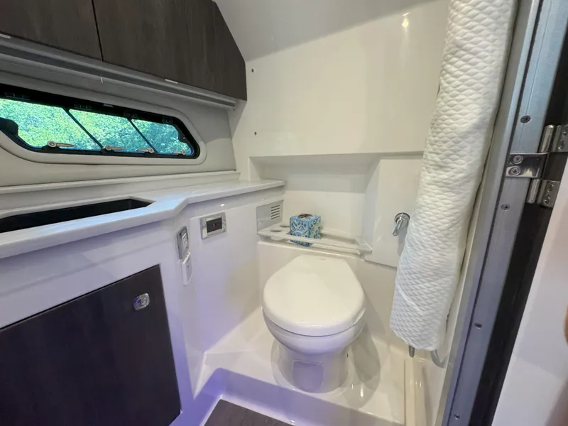 Slide: The Image of Interior of 2022 Formula 380 Super Sport Crossover OB boat bathroom with blue lighting. - 37