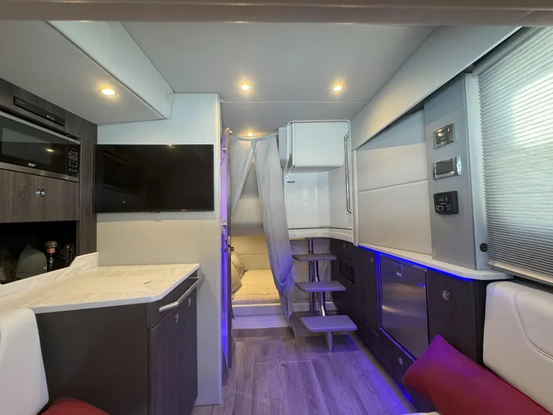 Slide: The Image of 2022 Formula 380 Super Sport Crossover OB interior with white seating and red cushions. - 42