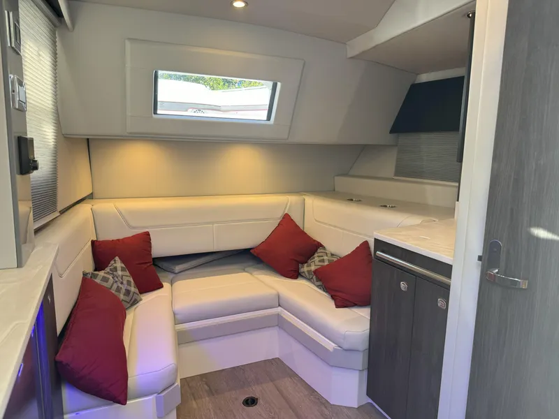 Slide: The Image of 2022 Formula 380 Super Sport Crossover OB interior with white seating and red cushions. - 43