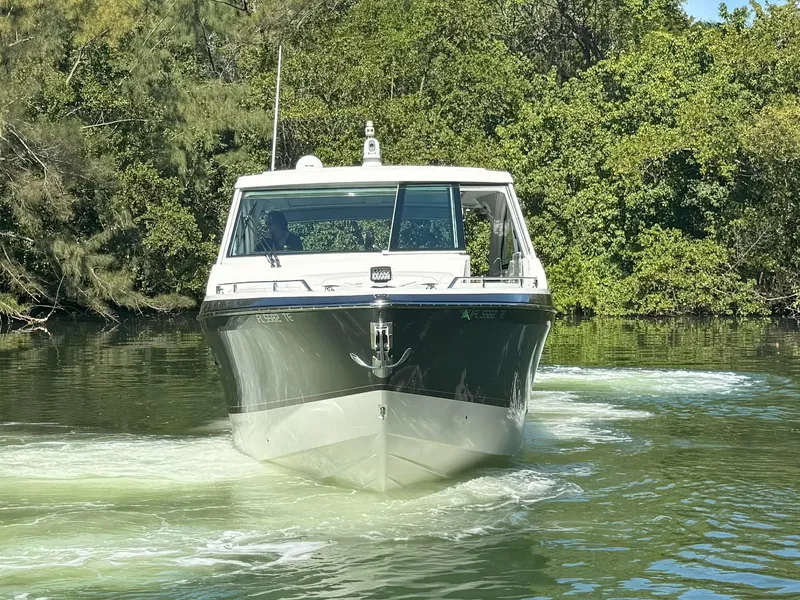 Slide: The Image of 2022 Formula 380 Super Sport Crossover OB cruising on a calm river. - 5