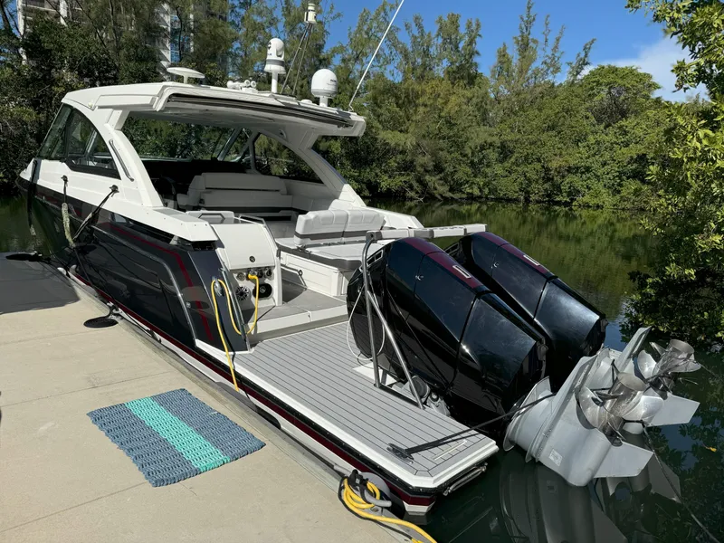 Slide: The Image of 2022 Formula 380 Super Sport Crossover OB docked by lush greenery. - 7