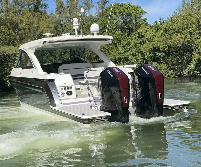 Slide: The Image of 2022 Formula 380 Super Sport Crossover OB boat with cushioned seating and speaker system. - 9