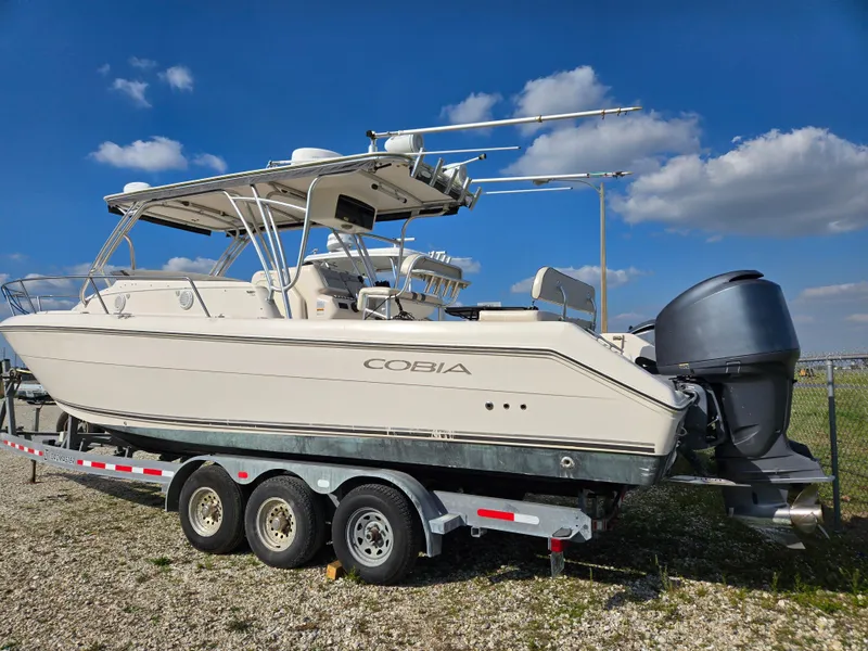 Slide: The Image of 2008 Cobia 316 Sport Cabin boat on trailer under blue sky. - 1