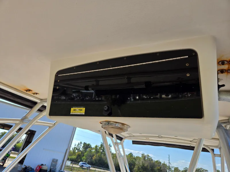 Slide: The Image of Overhead console of 2008 Cobia 316 Sport Cabin boat, featuring a sleek black panel. - 13