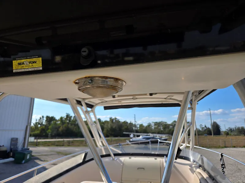 Slide: The Image of 2008 Cobia 316 Sport Cabin boat interior with overhead light and outdoor view. - 14