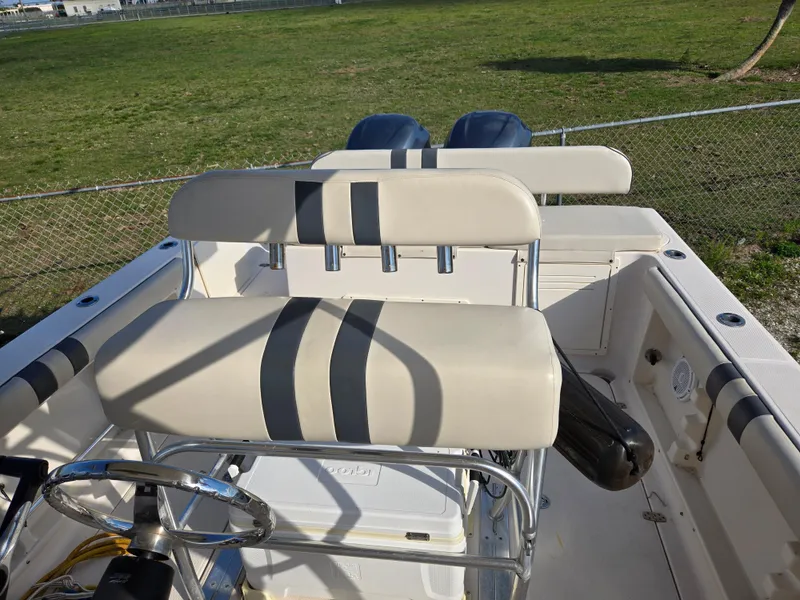 Slide: The Image of 2008 Cobia 316 Sport Cabin boat interior with dual seating and steering wheel. - 19
