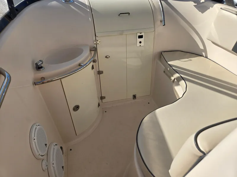 Slide: The Image of 2008 Cobia 316 Sport Cabin interior with seating and storage compartments. - 21