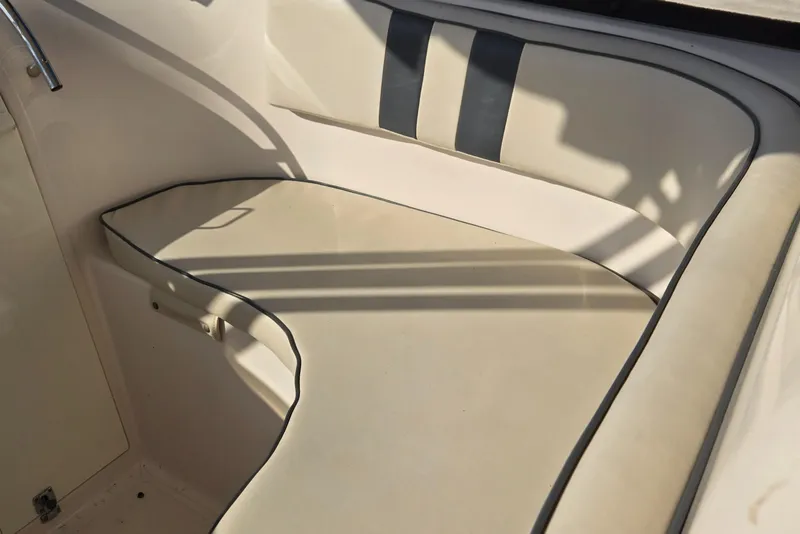 Slide: The Image of 2008 Cobia 316 Sport Cabin interior seating with beige upholstery and black trim. - 22