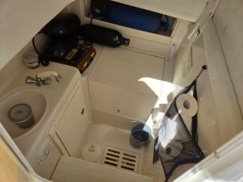 Slide: The Image of 2008 Cobia 316 Sport Cabin interior with sink, storage, and accessories. - 32