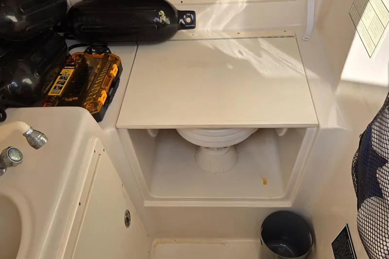 Slide: The Image of 2008 Cobia 316 Sport Cabin interior with storage and sink area. - 33