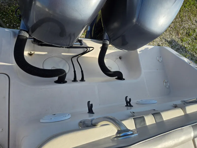 Slide: The Image of 2008 Cobia 316 Sport Cabin boat deck with dual engines and fittings. - 34