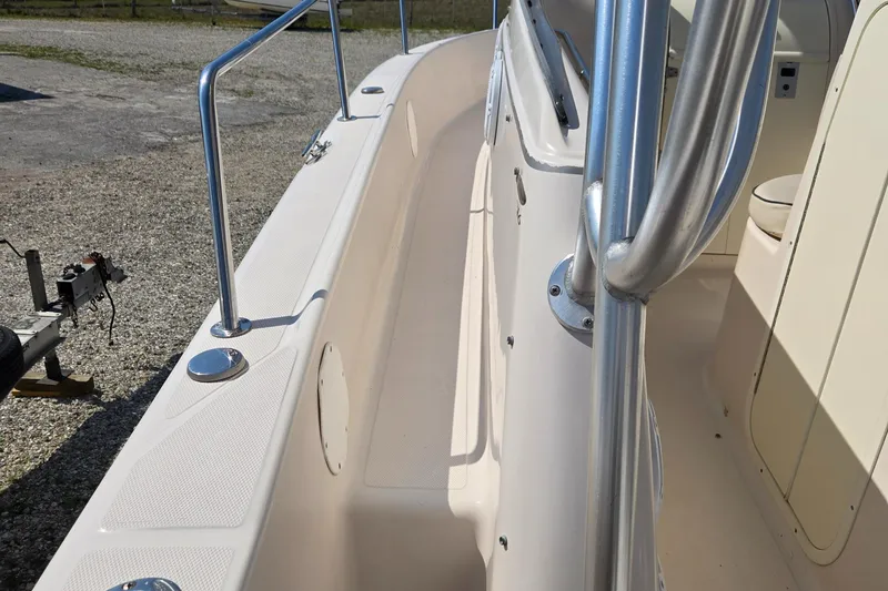 Slide: The Image of 2008 Cobia 316 Sport Cabin boat deck with stainless steel railings and seating area. - 36