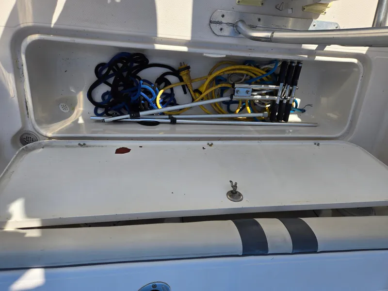 Slide: The Image of Storage compartment with cables on a 2008 Cobia 316 Sport Cabin boat. - 39