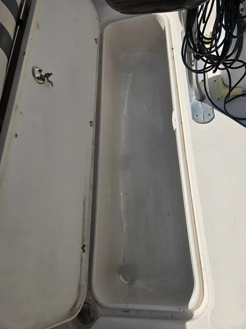 Slide: The Image of Open storage compartment on 2008 Cobia 316 Sport Cabin boat. - 40