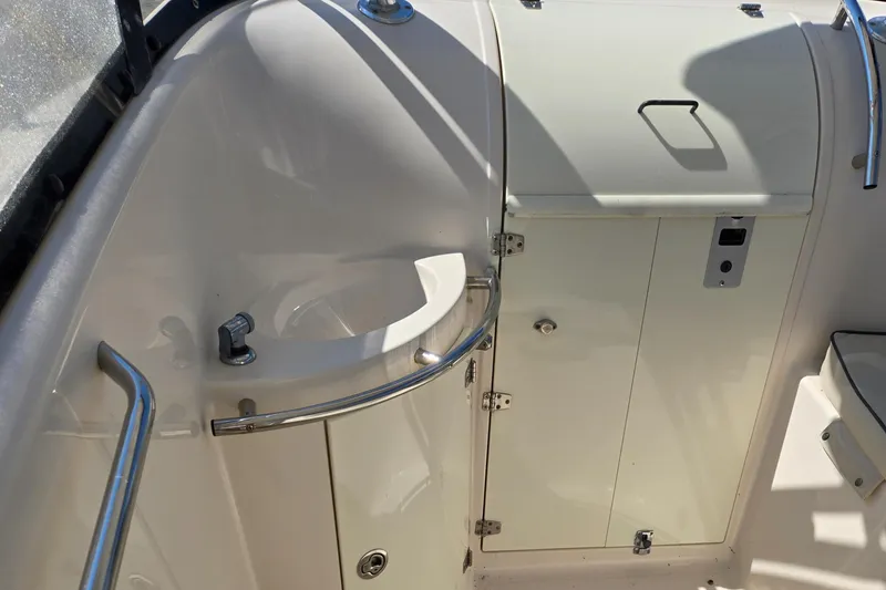 Slide: The Image of 2008 Cobia 316 Sport Cabin interior with storage compartments and stainless steel railings. - 42