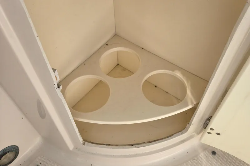 Slide: The Image of Cup holder compartment in 2008 Cobia 316 Sport Cabin boat interior. - 44