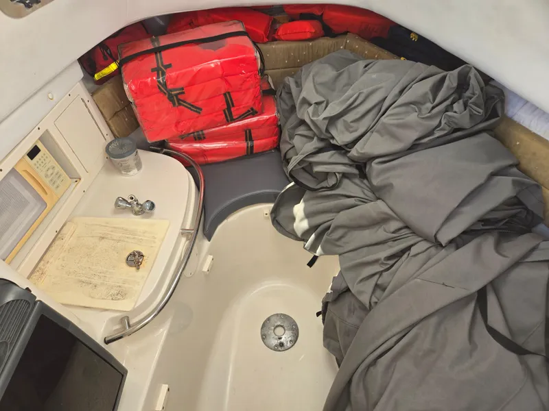Slide: The Image of 2008 Cobia 316 Sport Cabin interior with life jackets and nautical equipment. - 45