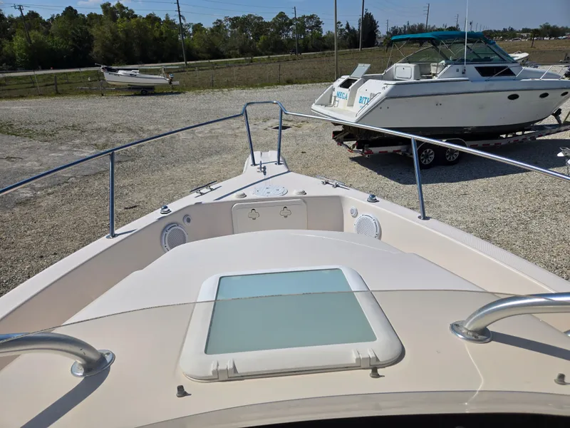 Slide: The Image of 2008 Cobia 316 Sport Cabin boat, docked with visible deck and railing. - 46