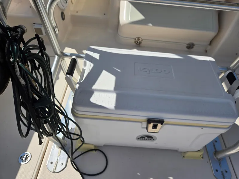 Slide: The Image of 2008 Cobia 316 Sport Cabin deck with Igloo cooler and coiled rope. - 47
