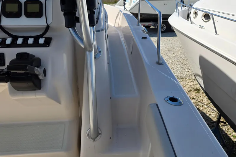 Slide: The Image of 2008 Cobia 316 Sport Cabin boat interior with control panel and railing. - 48