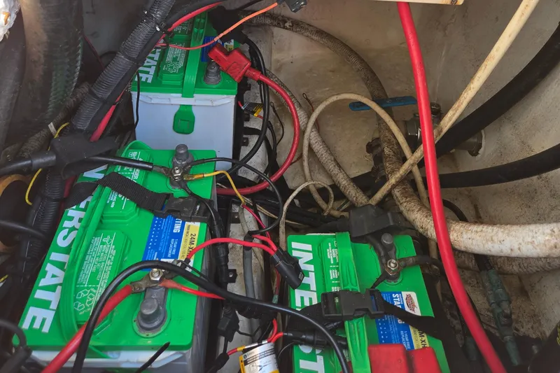 Slide: The Image of Battery compartment of 2008 Cobia 316 Sport Cabin with Interstate batteries and wiring. - 59