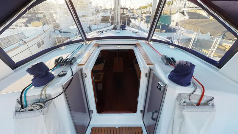 Slide: The Image of 2019 Beneteau Oceanis 38.1 yacht cockpit with open cabin entrance. - 10