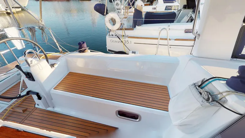Slide: The Image of 2019 Beneteau Oceanis 38.1 sailboat with teak deck, docked at marina. - 12