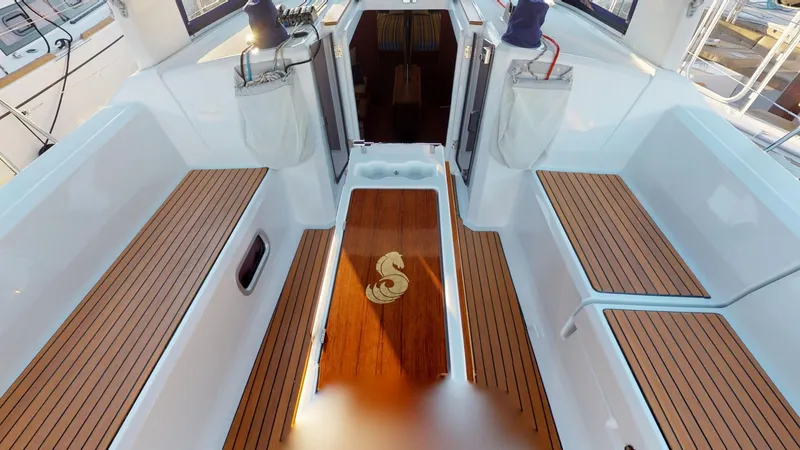 Slide: The Image of 2019 Beneteau Oceanis 38.1 yacht cockpit with teak flooring and seating. - 13