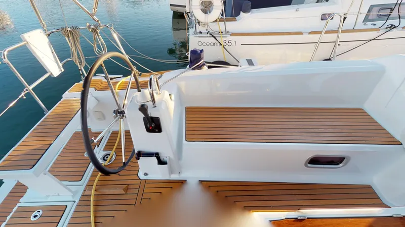 Slide: The Image of Cockpit of 2019 Beneteau Oceanis 38.1 sailboat with wooden deck and steering wheel. - 15
