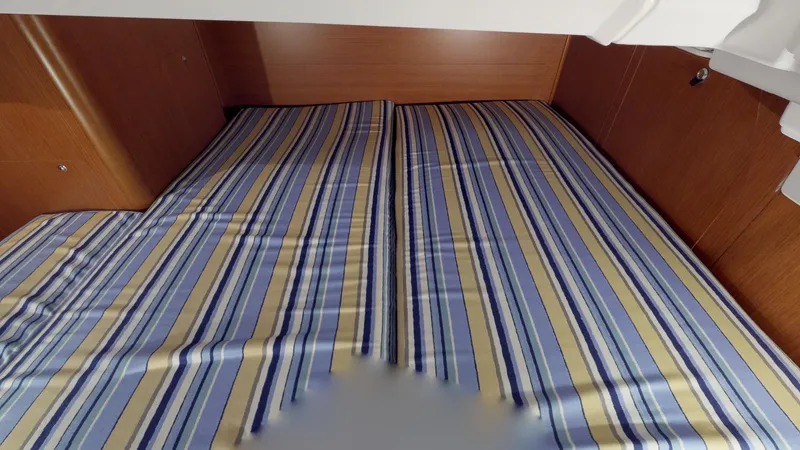 Slide: The Image of Cabin interior of 2019 Beneteau Oceanis 38.1 with striped bedding. - 17