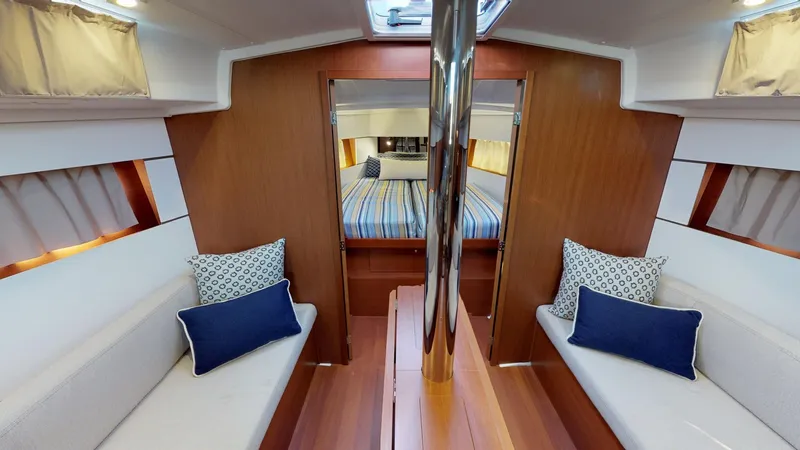 Slide: The Image of Interior of 2019 Beneteau Oceanis 38.1 yacht with cozy seating and elegant wood finish. - 24
