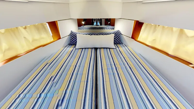 Slide: The Image of Interior cabin of 2019 Beneteau Oceanis 38.1 with striped bedding and cozy decor. - 32