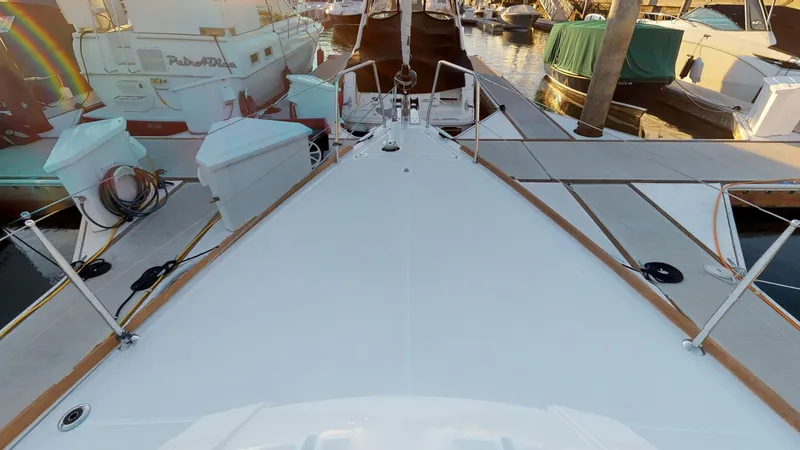 Slide: The Image of Beneteau Oceanis 38.1 yacht deck, 2019 model, docked at marina with surrounding boats. - 34
