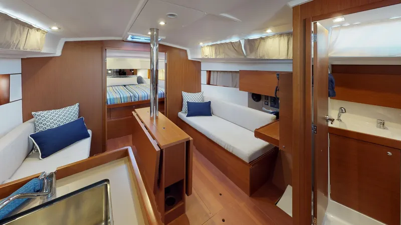 Slide: The Image of Interior of 2019 Beneteau Oceanis 38.1 yacht, featuring modern wood finish and cozy seating. - 37