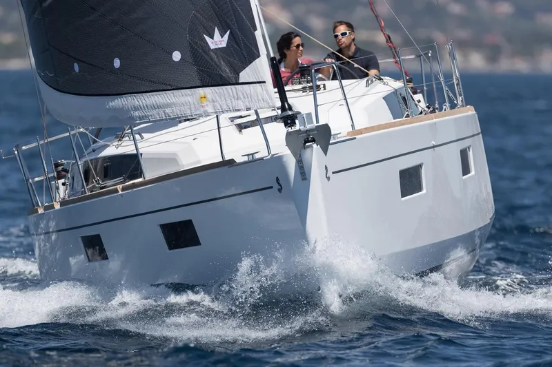 Slide: The Image of 2019 Beneteau Oceanis 38.1 sailing on open water with two people onboard. - 41