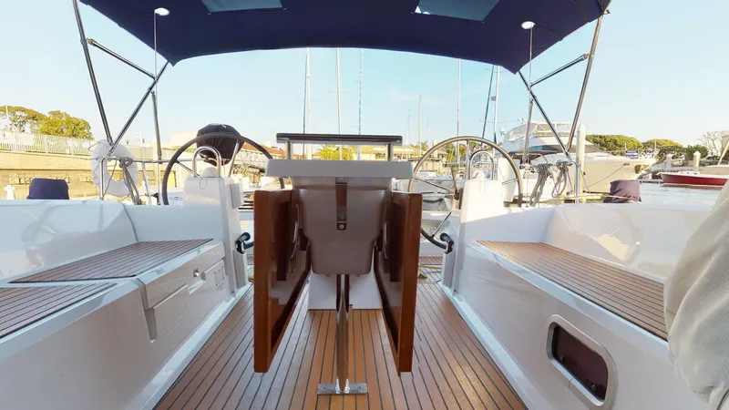 Slide: The Image of 2019 Beneteau Oceanis 38.1 yacht interior with wooden deck and dual steering wheels. - 6