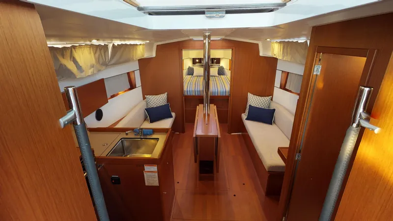 Slide: The Image of Interior of 2019 Beneteau Oceanis 38.1 sailboat, featuring cozy seating and modern amenities. - 7