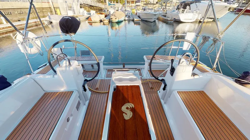 Slide: The Image of 2019 Beneteau Oceanis 38.1 yacht cockpit with dual steering wheels in marina. - 9